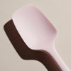 A close up of the Light Pink Spoonula on a cream background. 